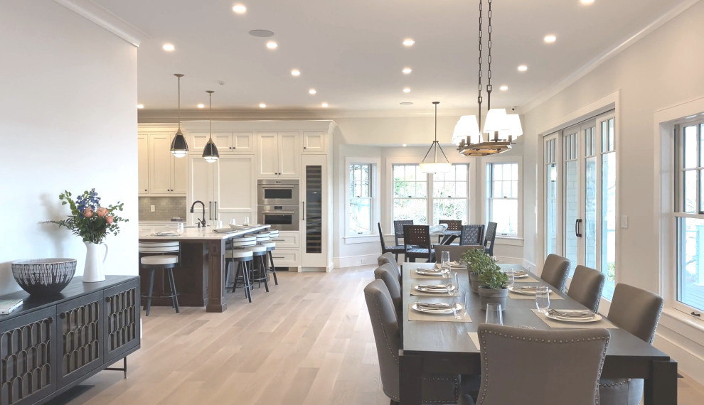 Inspiration for a large transitional light wood floor and beige floor kitchen/dining room combo remodel in Boston with white walls