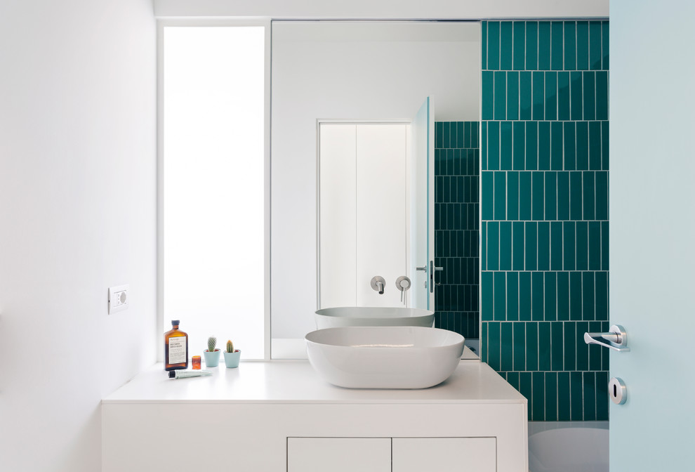 Design ideas for a small contemporary kids bathroom in Milan with flat-panel cabinets, white cabinets, an alcove tub, blue tile, green tile, porcelain tile, white walls, a vessel sink, solid surface benchtops and white benchtops.