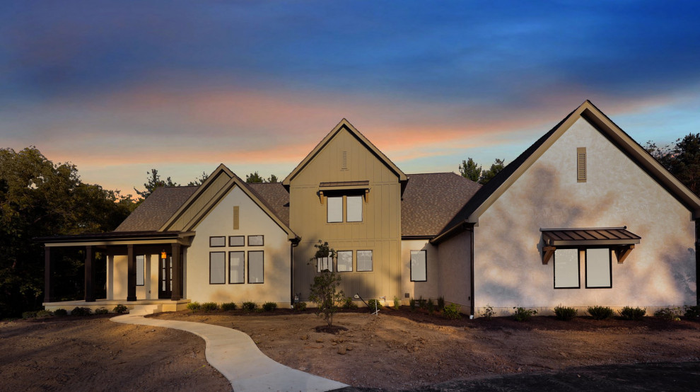 Example of a transitional beige two-story concrete fiberboard and board and batten gable roof design in Columbus with a mixed material roof