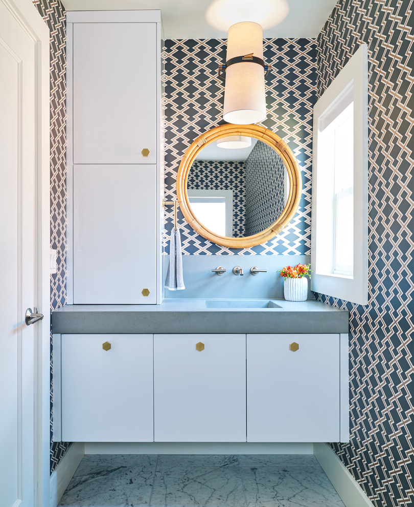 Inspiration for a contemporary powder room in Denver with flat-panel cabinets, white cabinets, multi-coloured walls, an integrated sink, grey floor and grey benchtops.
