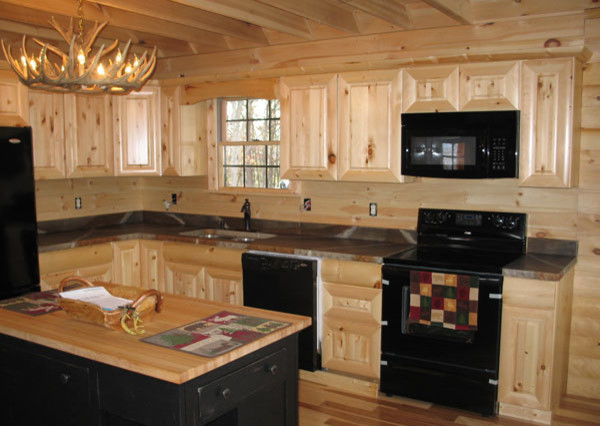 Example of a medium tone wood floor kitchen design with raised-panel cabinets, medium tone wood cabinets, granite countertops, beige backsplash, stainless steel appliances and an island