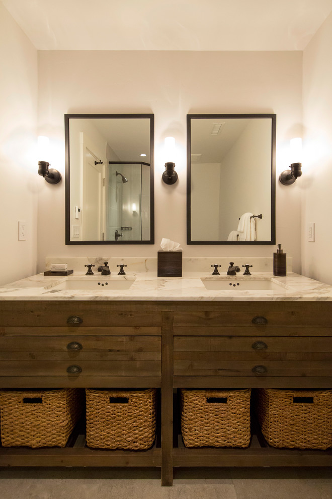 Example of a mid-sized transitional master ceramic tile corner shower design in Denver with furniture-like cabinets, distressed cabinets, beige walls, an undermount sink, marble countertops and a hinged shower door