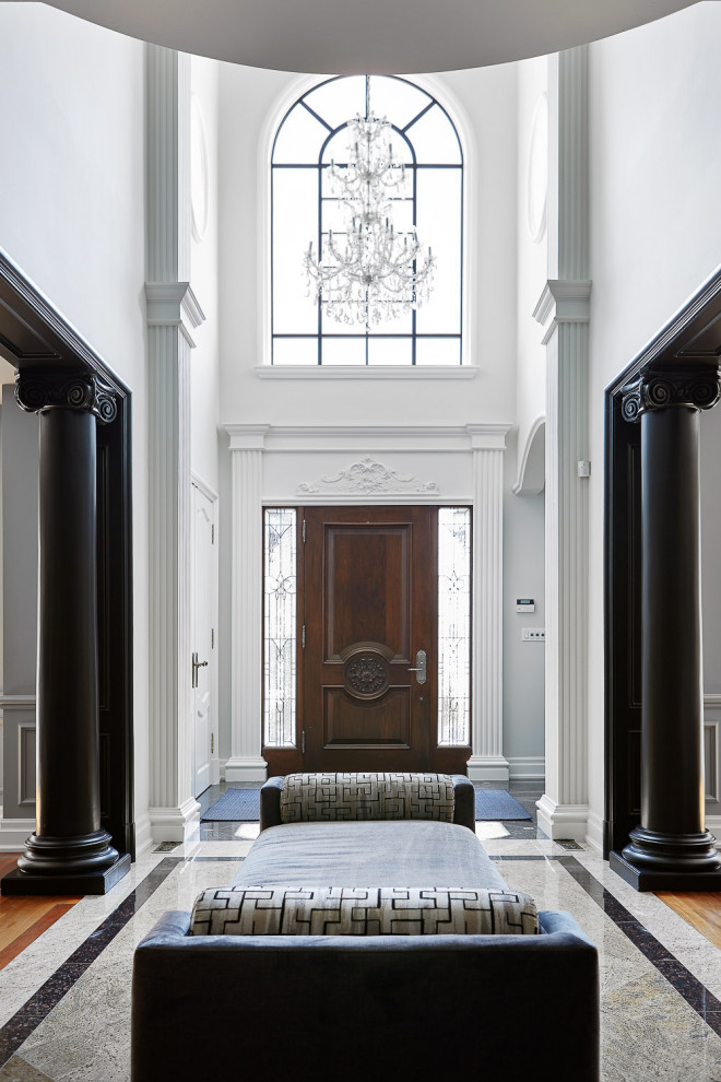 Inspiration for a large timeless entry hall remodel in Toronto with white walls and a dark wood front door