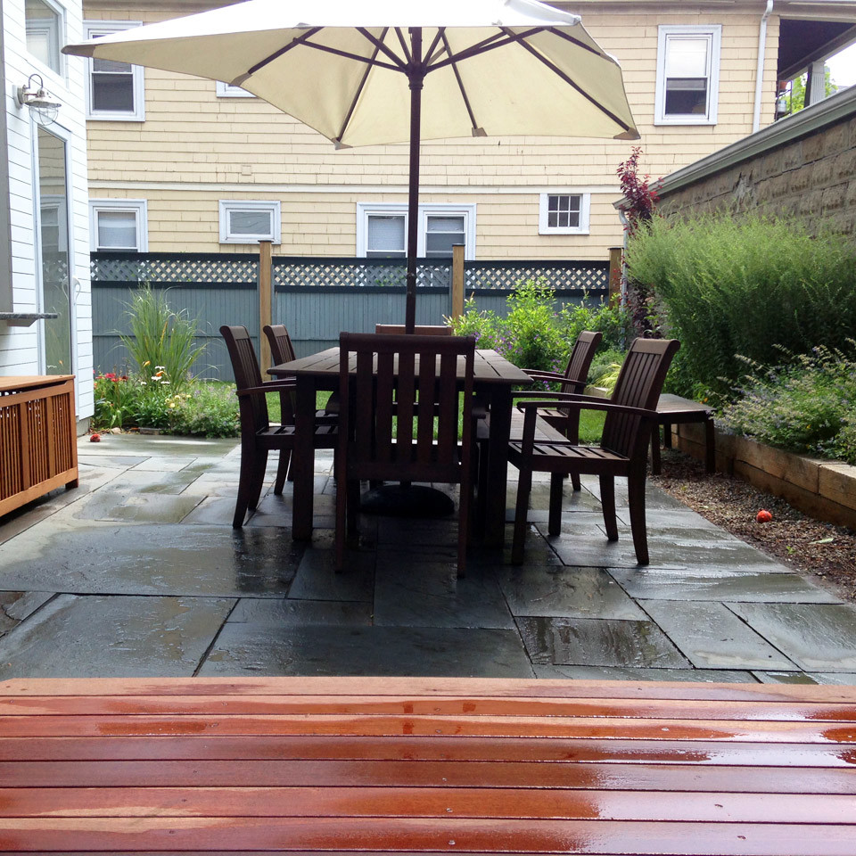 Photo of a small contemporary backyard patio in Boston with concrete pavers and no cover.