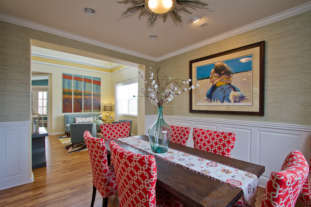 This is an example of a mid-sized beach style separate dining room in Denver with green walls, medium hardwood floors, no fireplace and brown floor.