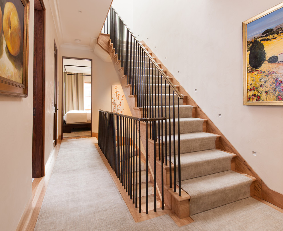 This is an example of a large transitional wood l-shaped staircase in DC Metro with wood risers and metal railing.