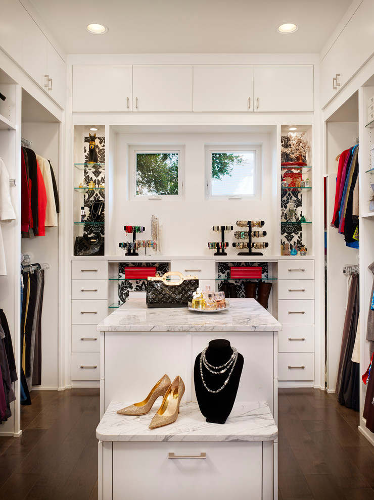 This is an example of a contemporary walk-in wardrobe in Austin with dark hardwood floors.