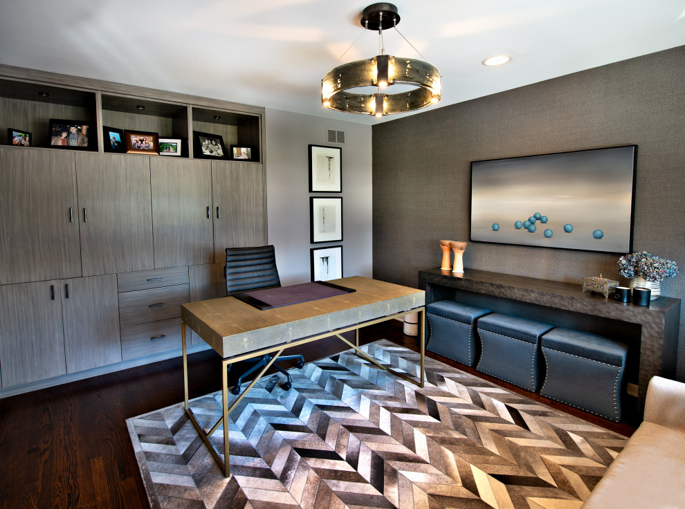 This is an example of a mid-sized contemporary home office in Chicago with grey walls, medium hardwood floors, a freestanding desk and wallpaper.
