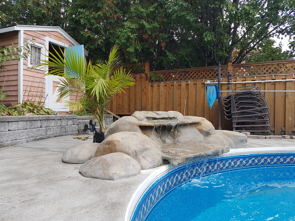 Stamped Concrete Pool Deck with Waterfall Toronto by King Concrete