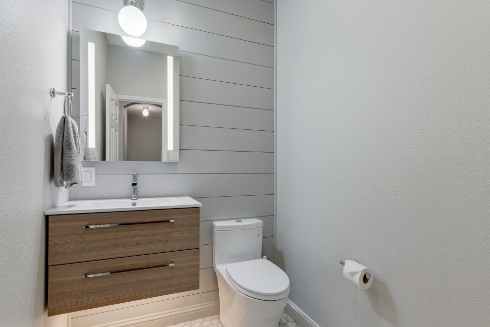 Inspiration pour un petit WC et toilettes traditionnel en bois foncé avec un placard à porte plane, WC à poser, un carrelage gris, un mur gris, un sol en marbre, un lavabo intégré, un plan de toilette en surface solide, un sol gris, un plan de toilette blanc, meuble-lavabo suspendu et du lambris de bois.