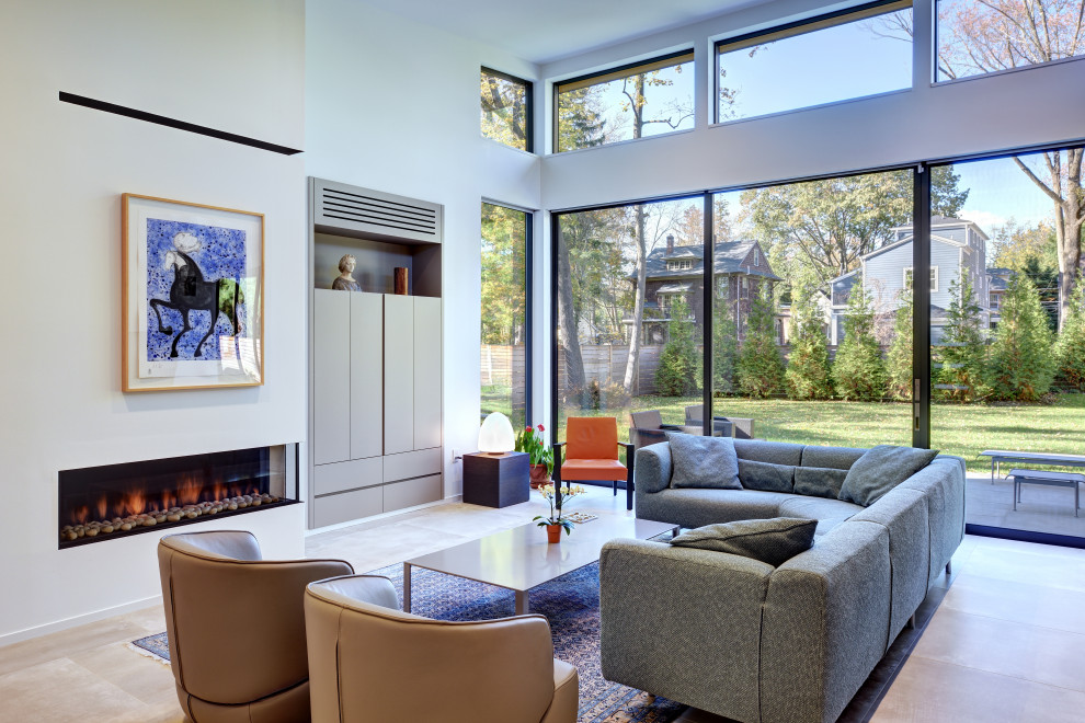Photo of a large contemporary open concept family room in Philadelphia with white walls, concrete floors, a corner fireplace, a concrete fireplace surround, a concealed tv and grey floor.
