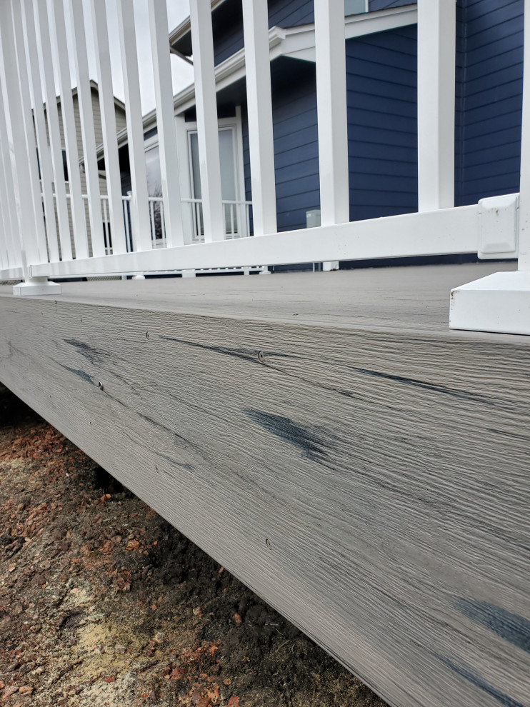 This is an example of a mid-sized backyard and ground level deck in Other with with skirting, no cover and metal railing.