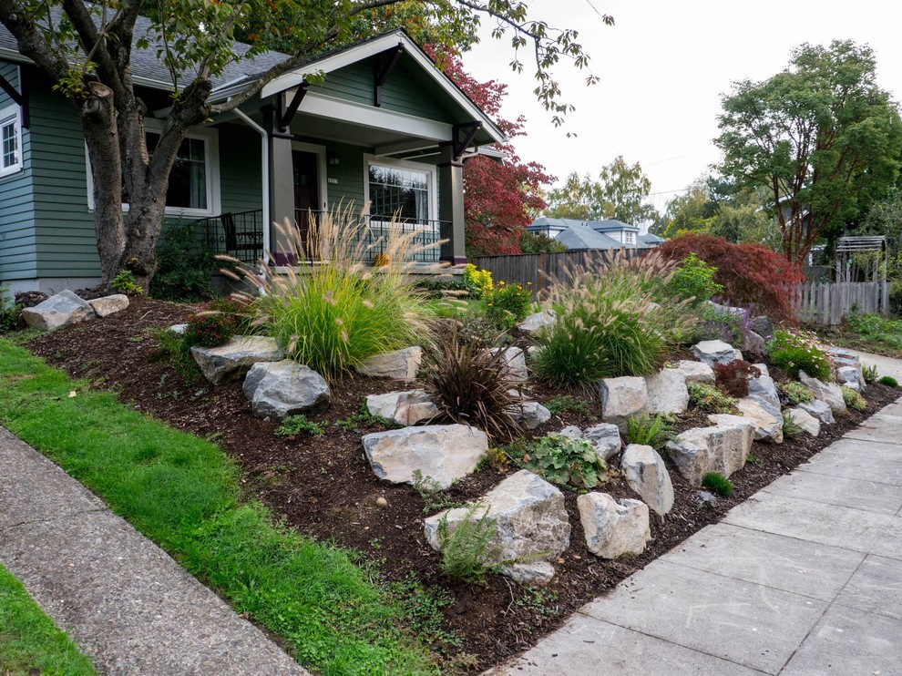 Mid-sized traditional front yard full sun garden in Portland with a retaining wall.