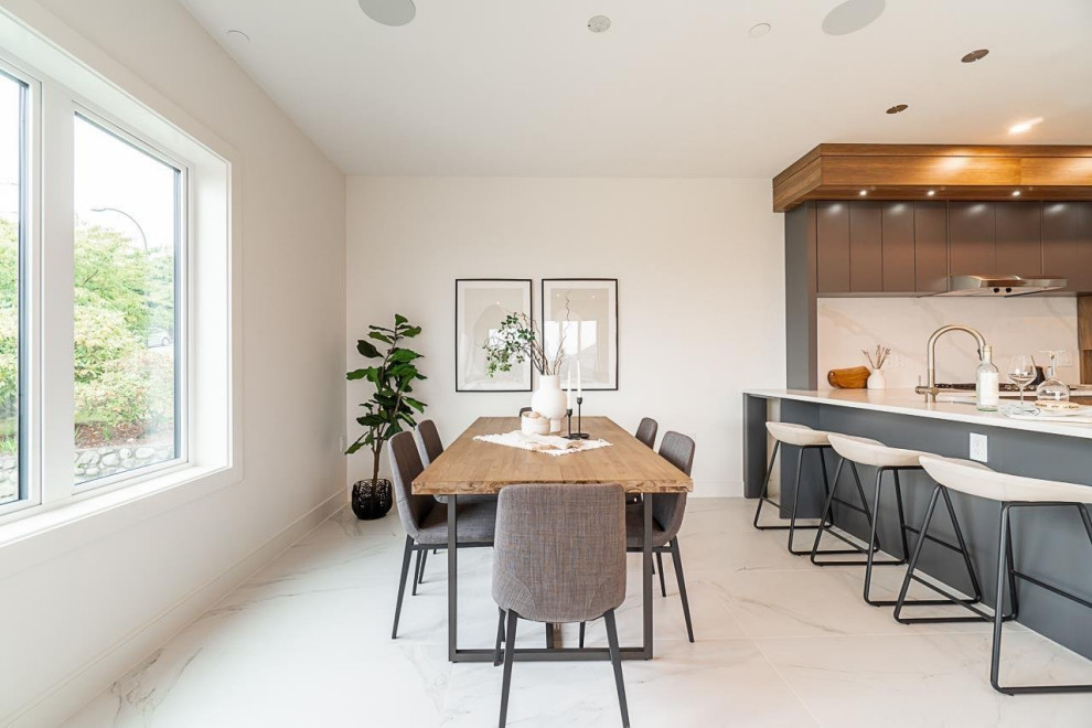 Mid-sized ceramic tile and white floor kitchen/dining room combo photo in Vancouver with white walls and no fireplace