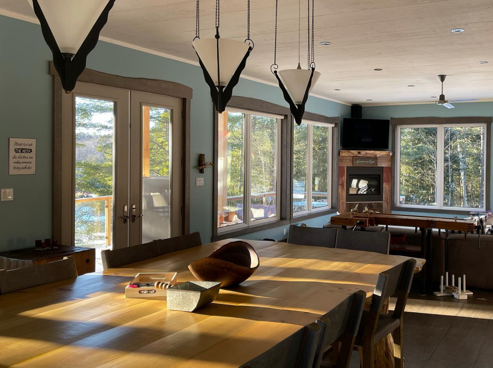 Photo of a large modern study in Toronto with blue walls, brown floors and a wood ceiling.