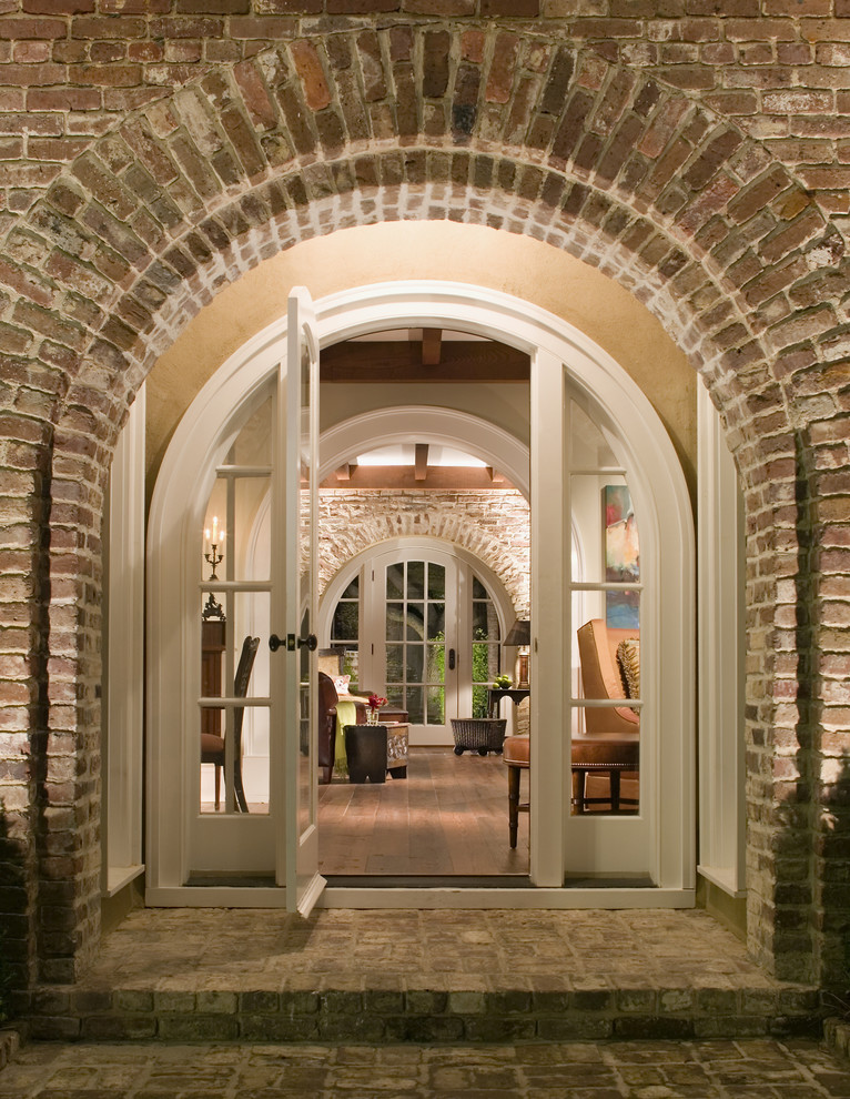 Photo of a traditional entryway in Atlanta with a white front door, brick floors and a single front door.