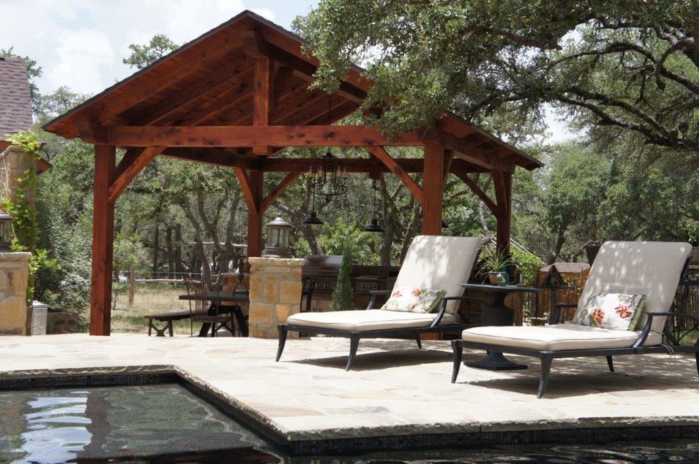 Pool fountain - mid-sized rustic backyard stone and rectangular lap pool fountain idea in Austin