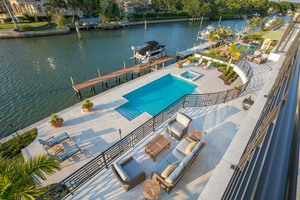 Photo of a transitional backyard deck in Tampa with with dock.