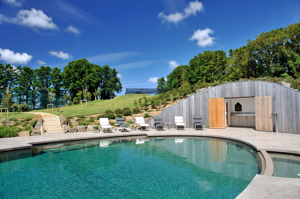 Inspiration for a large contemporary pool in Cornwall with a hot tub.