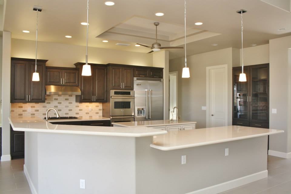 Example of a large transitional u-shaped porcelain tile eat-in kitchen design in Phoenix with an undermount sink, raised-panel cabinets, dark wood cabinets, quartz countertops, beige backsplash, porcelain backsplash, stainless steel appliances and an island