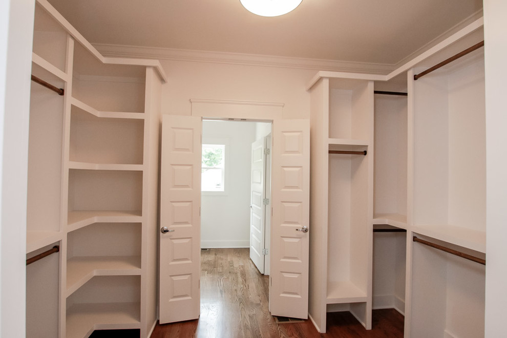 Design ideas for a mid-sized beach style gender-neutral walk-in wardrobe in Nashville with open cabinets, white cabinets and medium hardwood floors.