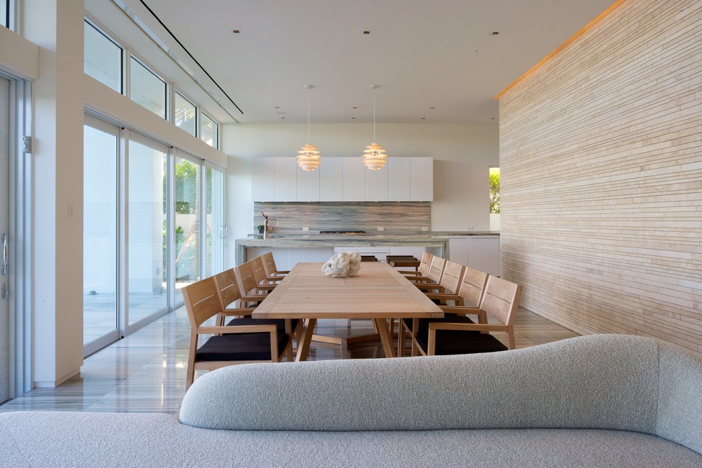 Contemporary open plan dining in Miami with white walls.