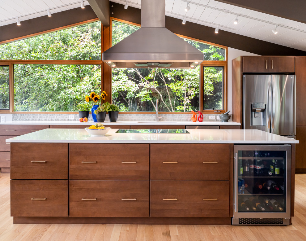 Mid-sized midcentury u-shaped kitchen in Other with a single-bowl sink, flat-panel cabinets, medium wood cabinets, quartzite benchtops, green splashback, porcelain splashback, stainless steel appliances, light hardwood floors, with island, beige floor, white benchtop and exposed beam.