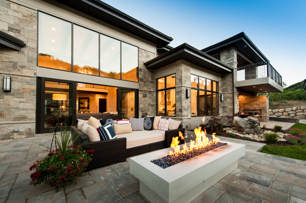 Design ideas for a contemporary backyard patio in Salt Lake City with a fire feature, natural stone pavers and no cover.