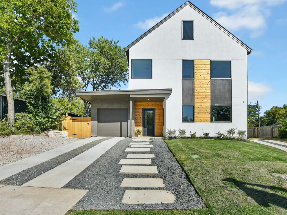 Medium sized and white modern render detached house in Austin with three floors, a pitched roof, a mixed material roof, a black roof and shiplap cladding.