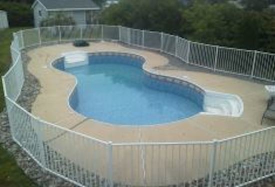 Inspiration for a mid-sized backyard concrete paver and custom-shaped pool remodel