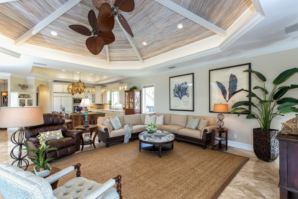 Design ideas for a tropical open concept family room in Miami with beige walls.