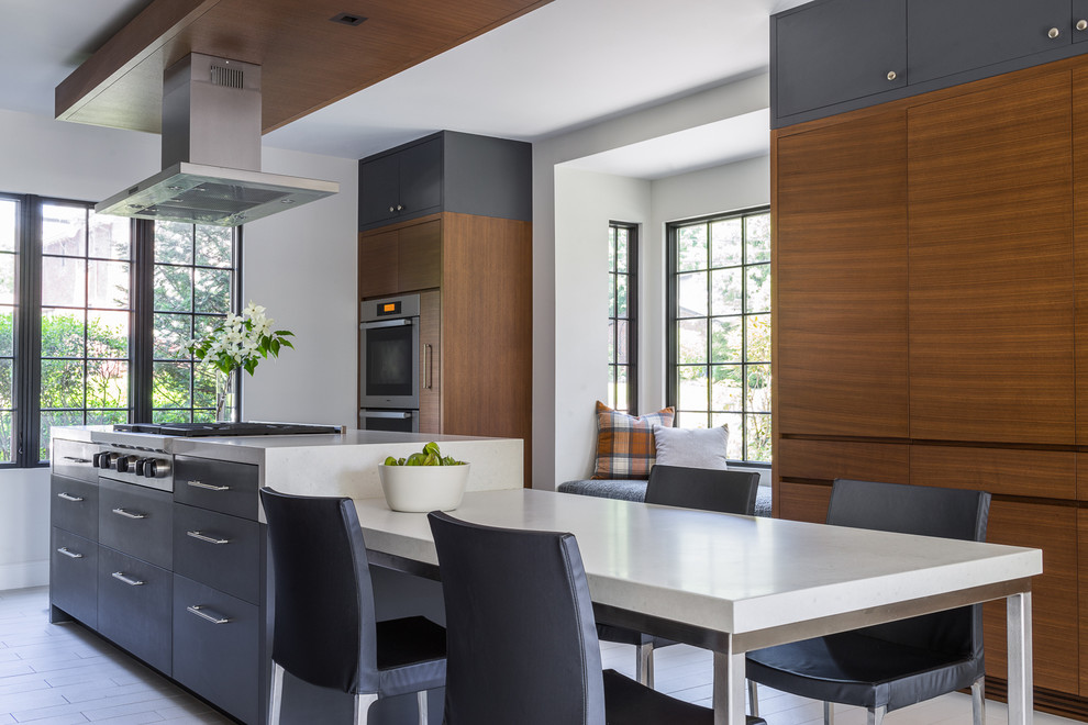Inspiration for a contemporary galley eat-in kitchen in Boston with flat-panel cabinets, medium wood cabinets, stainless steel appliances and with island.