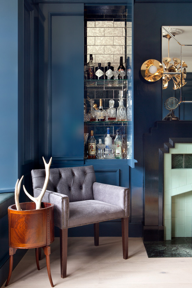 Photo of a transitional home bar in Dublin with blue cabinets.