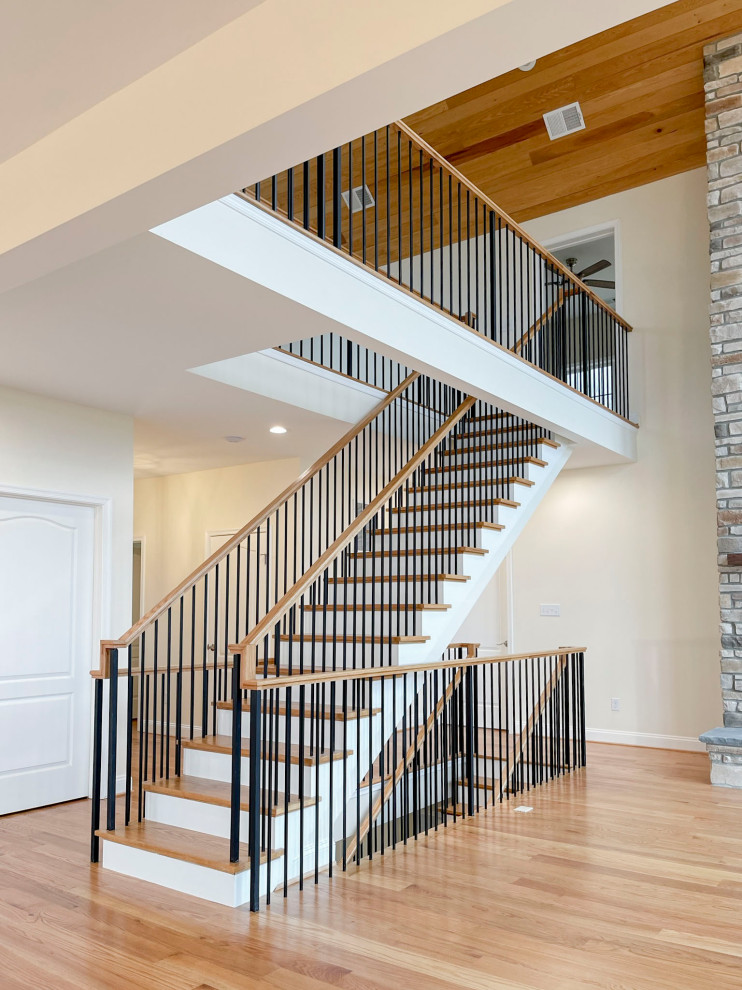 Inspiration for a large transitional wooden floating mixed material railing and shiplap wall staircase remodel in DC Metro with wooden risers