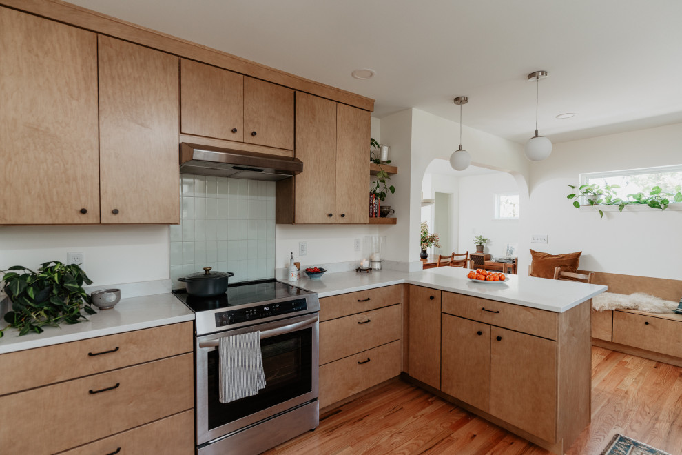 Mid-sized 1960s l-shaped medium tone wood floor kitchen pantry photo in Detroit with an undermount sink, flat-panel cabinets, light wood cabinets, quartz countertops, white backsplash, quartz backsplash, stainless steel appliances, a peninsula and white countertops