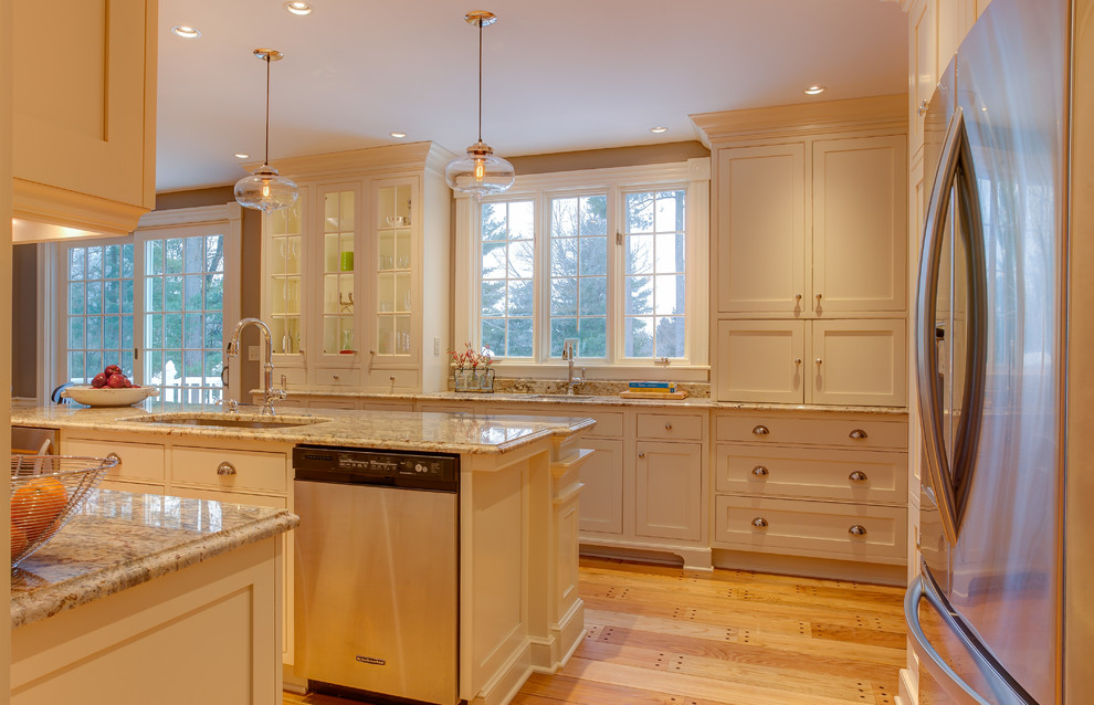 Eat-in kitchen - mid-sized transitional galley light wood floor eat-in kitchen idea in Boston with an undermount sink, beaded inset cabinets, white cabinets, quartzite countertops, stainless steel appliances and an island