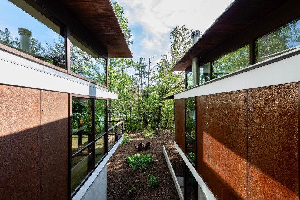 Mid-sized modern one-story metal house exterior idea in Atlanta with a butterfly roof and a white roof