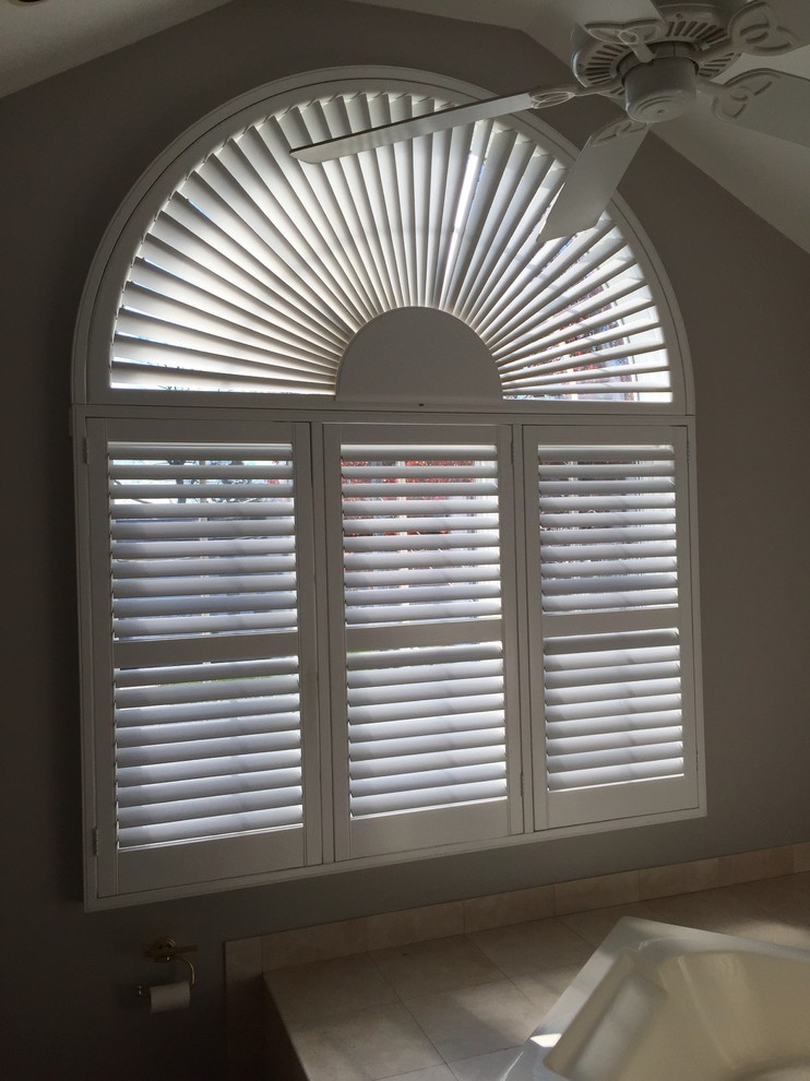 Lafayette Woodland Harvest Plantation shutters with Louver Mover. Arch is Motori