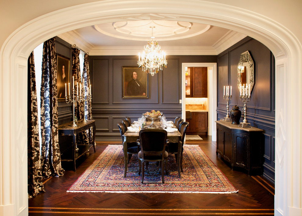 This is an example of a large mediterranean dining room in Philadelphia with black walls and dark hardwood floors.