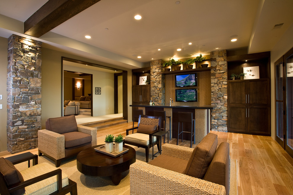 Photo of a country living room in Salt Lake City with a home bar and beige walls.