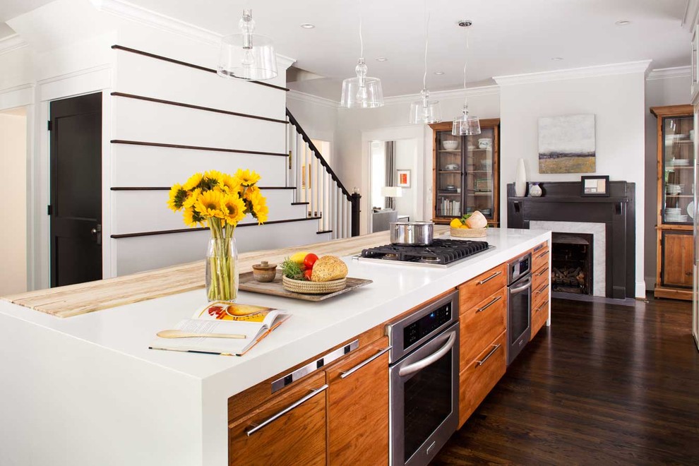Design ideas for a mid-sized contemporary galley open plan kitchen in Atlanta with an undermount sink, grey cabinets, solid surface benchtops, stainless steel appliances, dark hardwood floors, with island, white benchtop and flat-panel cabinets.
