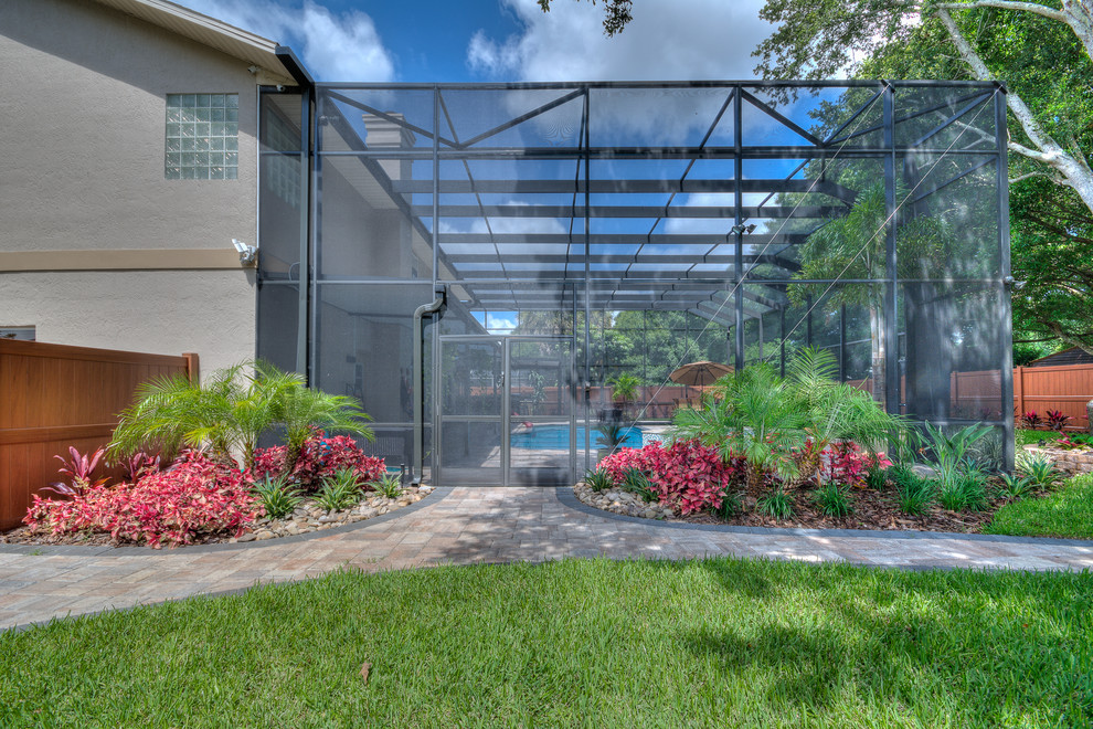 Inspiration for a large transitional backyard stone and custom-shaped lap hot tub remodel in Orlando
