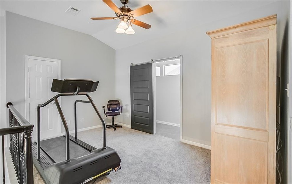 This is an example of a mid-sized transitional multipurpose gym in Dallas with grey walls, carpet and beige floor.