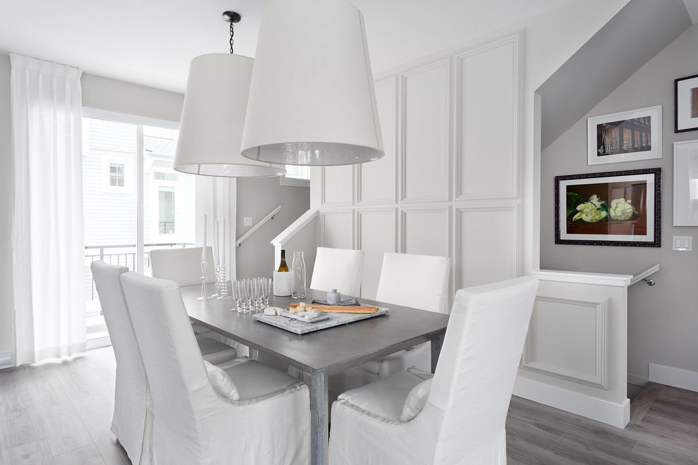 Inspiration for a transitional dining room in Vancouver with grey walls, no fireplace and grey floor.