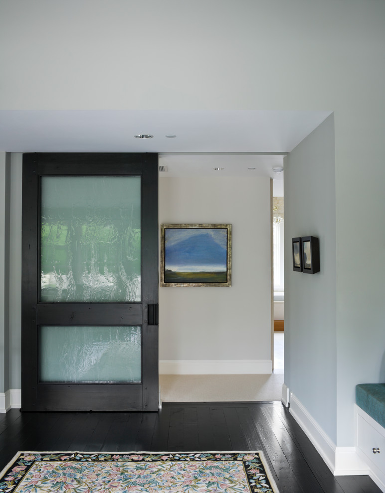 This is an example of a transitional hallway in New York with black floor.