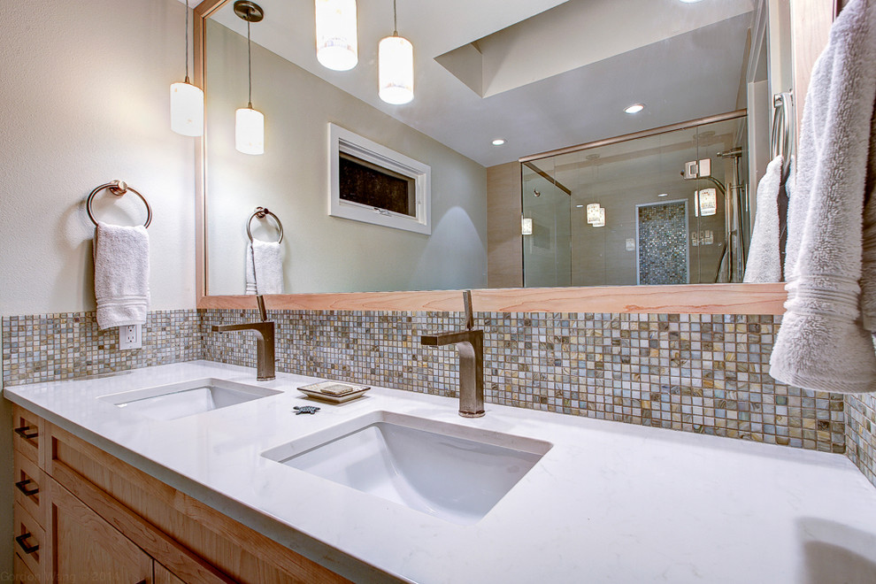 Photo of a mid-sized contemporary master bathroom in Seattle with an undermount sink, shaker cabinets, light wood cabinets, engineered quartz benchtops, a curbless shower, a one-piece toilet, beige tile, mosaic tile, white walls and marble floors.