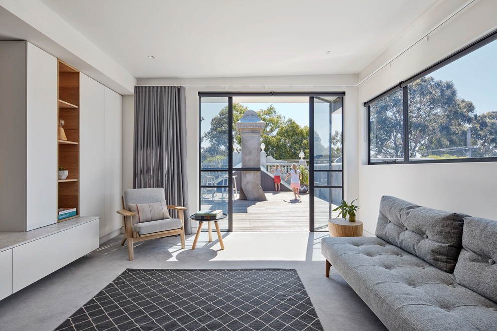This is an example of a contemporary family room in Melbourne with white walls, carpet and grey floor.