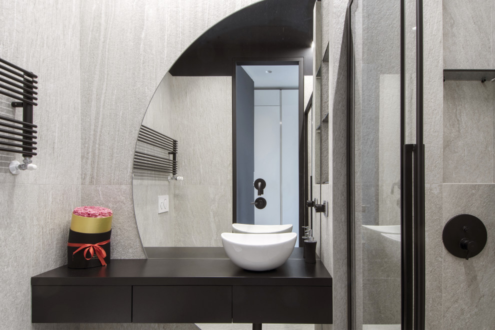 This is an example of a small contemporary cloakroom in Turin with flat-panel cabinets, black cabinets, a two-piece toilet, white tiles, porcelain tiles, white walls, porcelain flooring, a vessel sink, white floors, black worktops, a floating vanity unit and a drop ceiling.