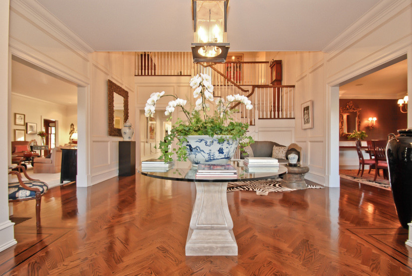 Design ideas for a large traditional foyer in New York with white walls and medium hardwood floors.