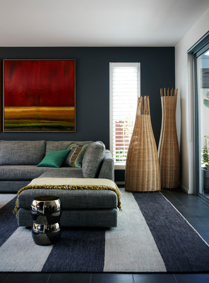 This is an example of a large contemporary open concept living room in Melbourne with black walls, ceramic floors and black floor.
